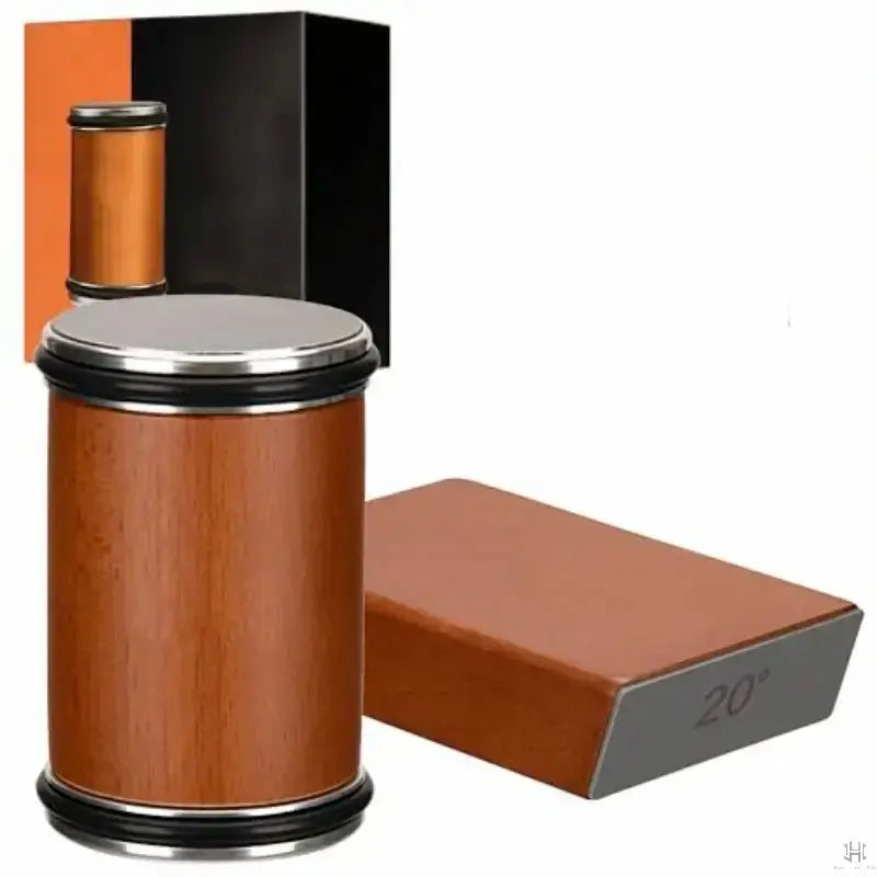 Wooden bottle with metal cap and a brown leather block on a white background